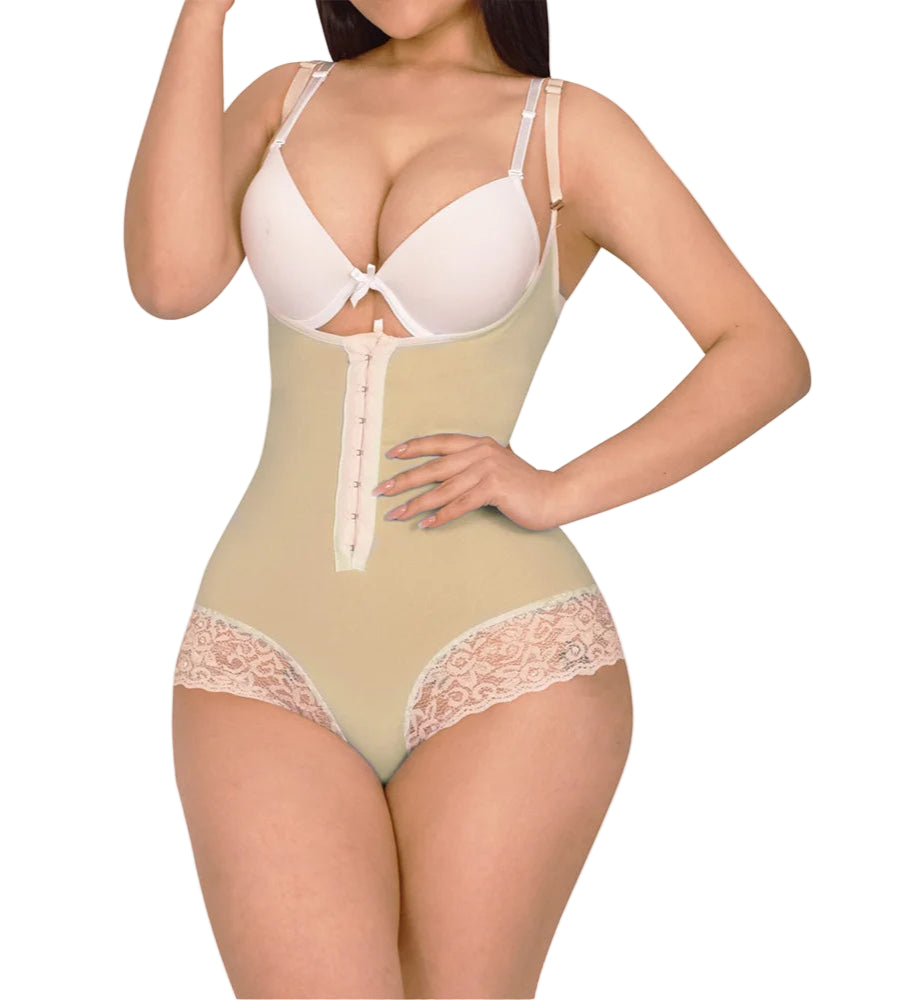 Woman wearing a beige shapewear garment with lace details on a white background