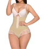Woman wearing a beige shapewear garment with lace details on a white background