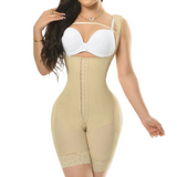 Woman wearing a beige body shaper and white bra on a white background