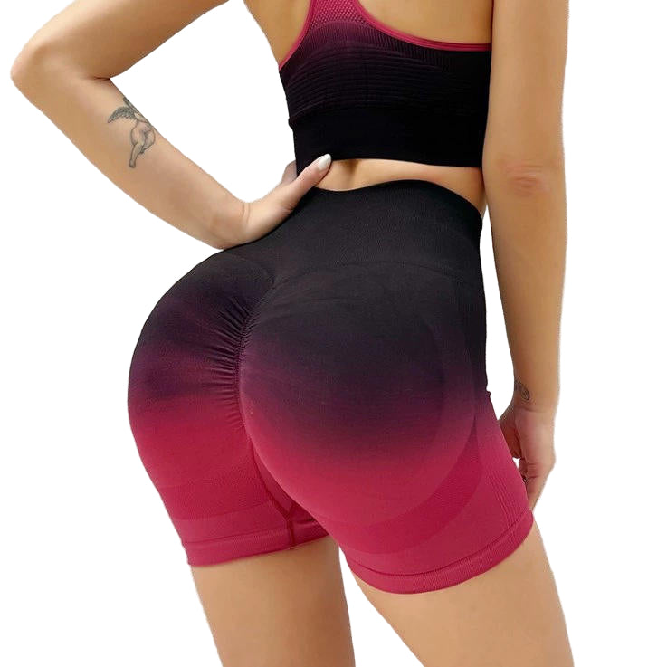 Person wearing a black and pink gradient athletic outfit on a textured white background