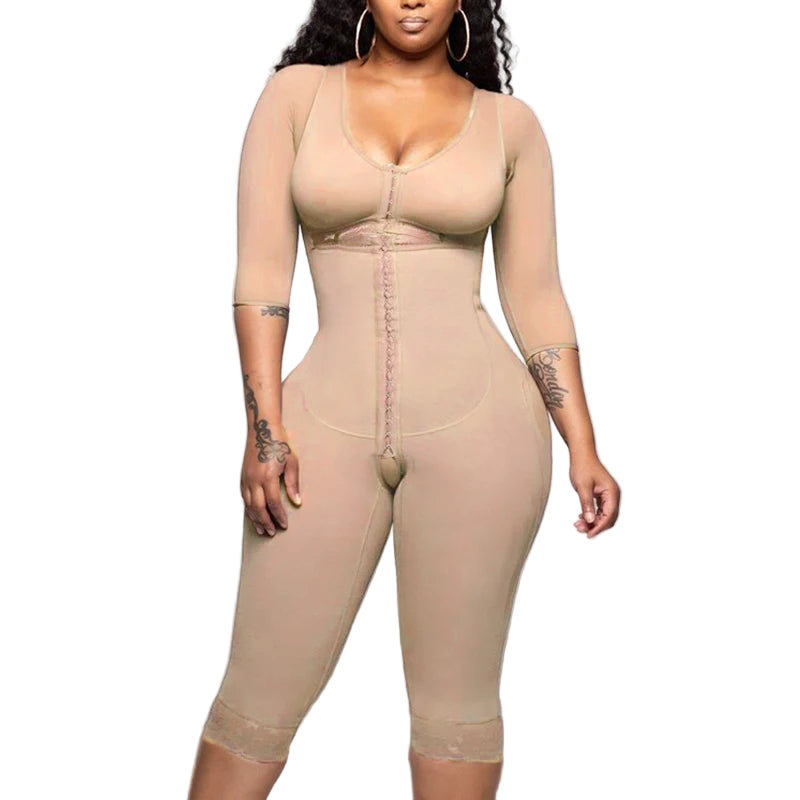 Woman wearing a beige shapewear jumpsuit on a plain background
