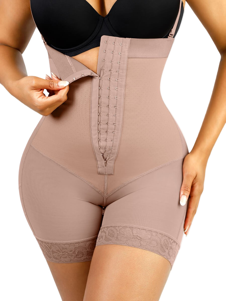 Beige shapewear being worn with a black bra on a neutral background