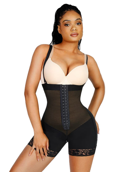 Woman wearing a black shapewear bodysuit on a plain background