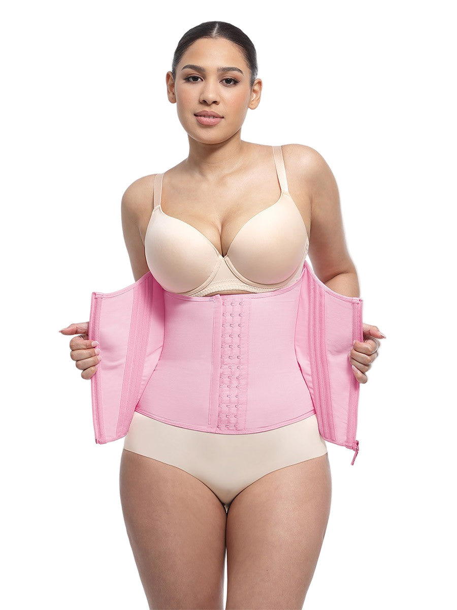 Woman wearing a pink waist trainer with beige bra and underwear on a white background
