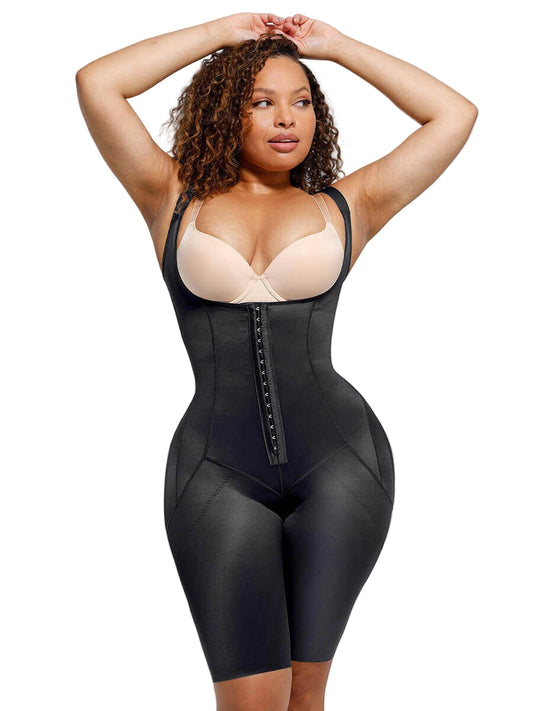 Woman wearing a black waist trainer with beige bra on a plain background