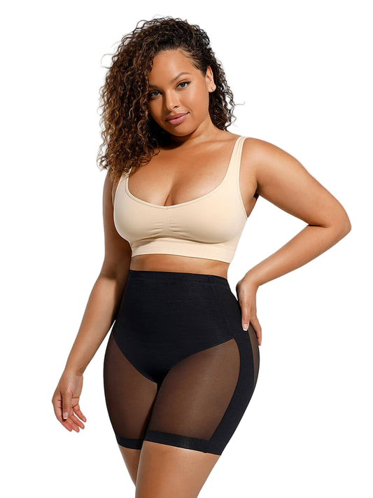 Woman wearing a beige sports bra and black high-waisted leggings with mesh panels on a white background