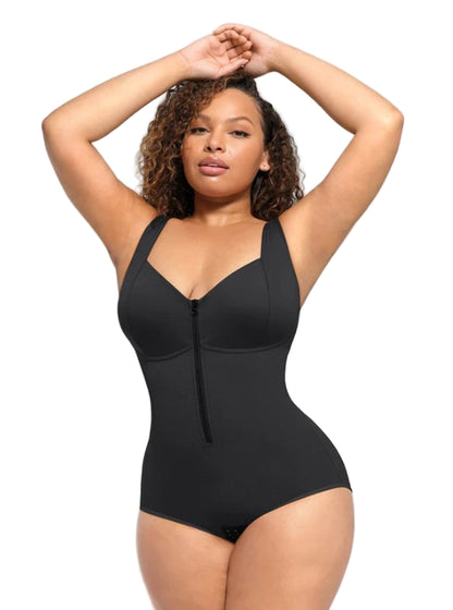 Woman wearing a black shapewear bodysuit against a plain background