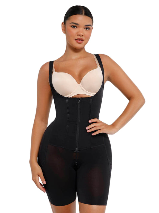 Woman wearing a black shapewear garment over a beige bra on a white background