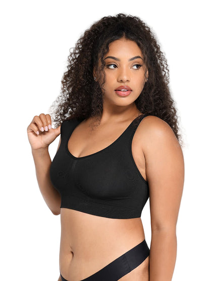 Woman wearing a black sports bra against a plain background