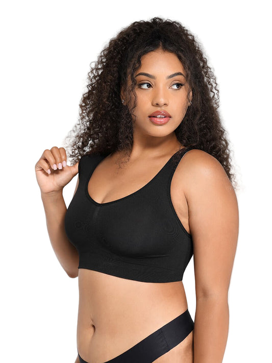 Woman wearing a black sports bra against a plain background