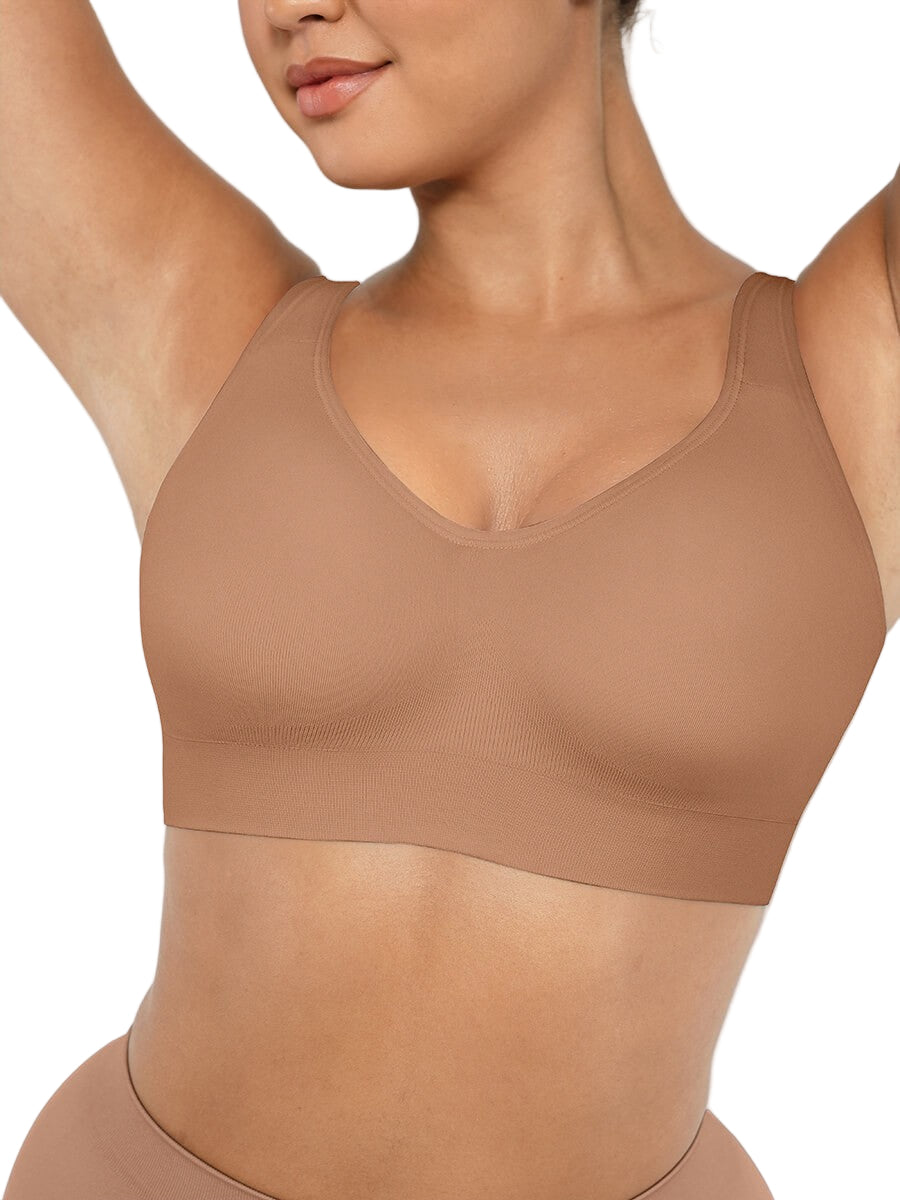 Woman wearing a beige compression garment against a white background