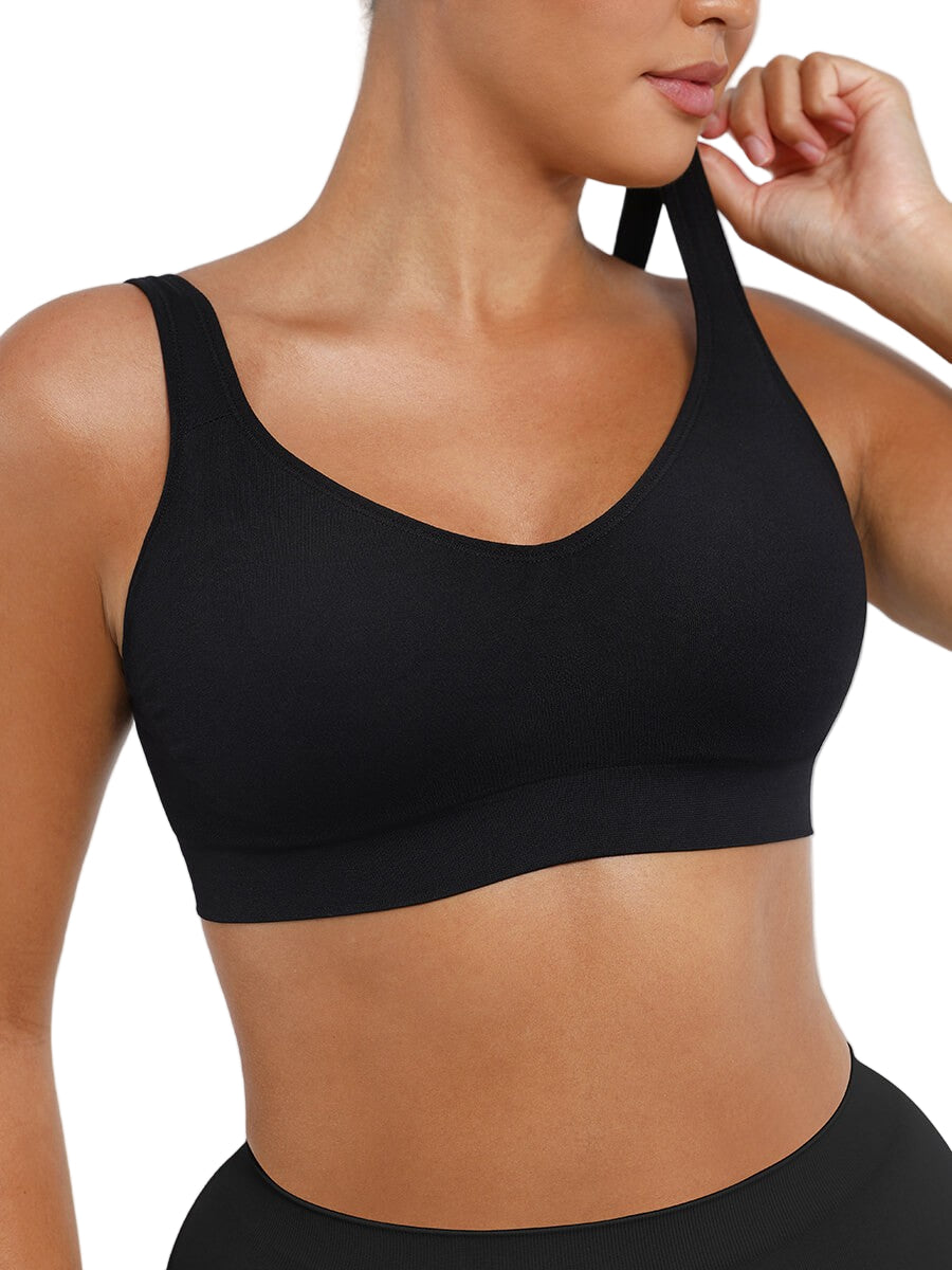 Black sports bra worn by a person on a plain background
