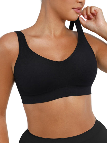 Black sports bra worn by a person on a plain background