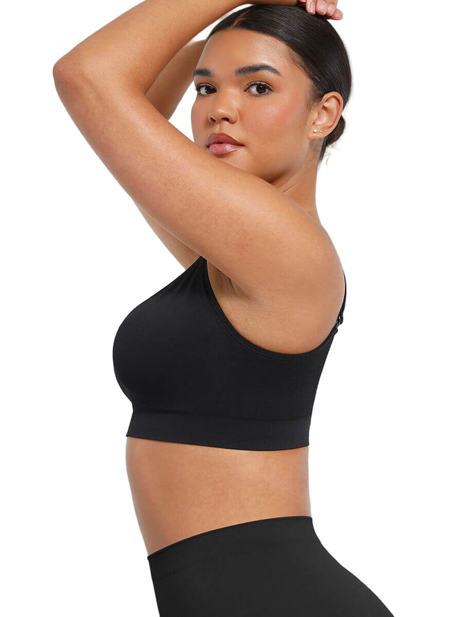 Woman wearing a black sports bra and leggings on a white background