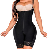Black shapewear with a beige bra on a gray background