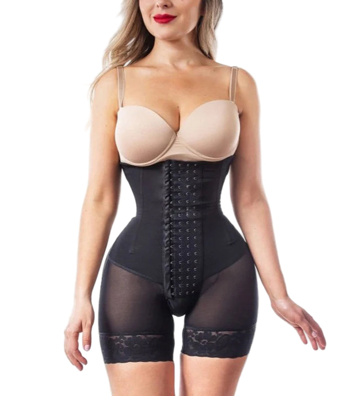 Woman wearing a black waist trainer with beige bra on a white background