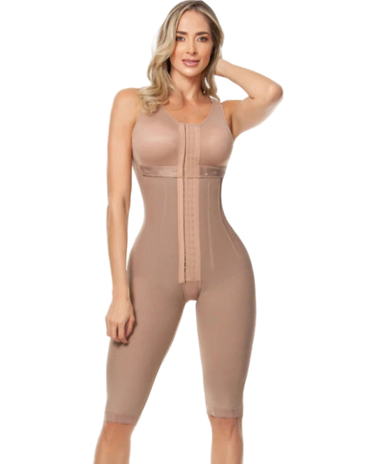 Woman wearing a beige shapewear jumpsuit on a white background