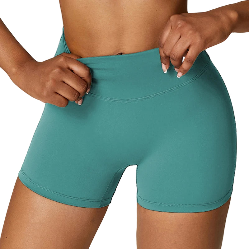 Teal athletic shorts worn by a person on a plain background