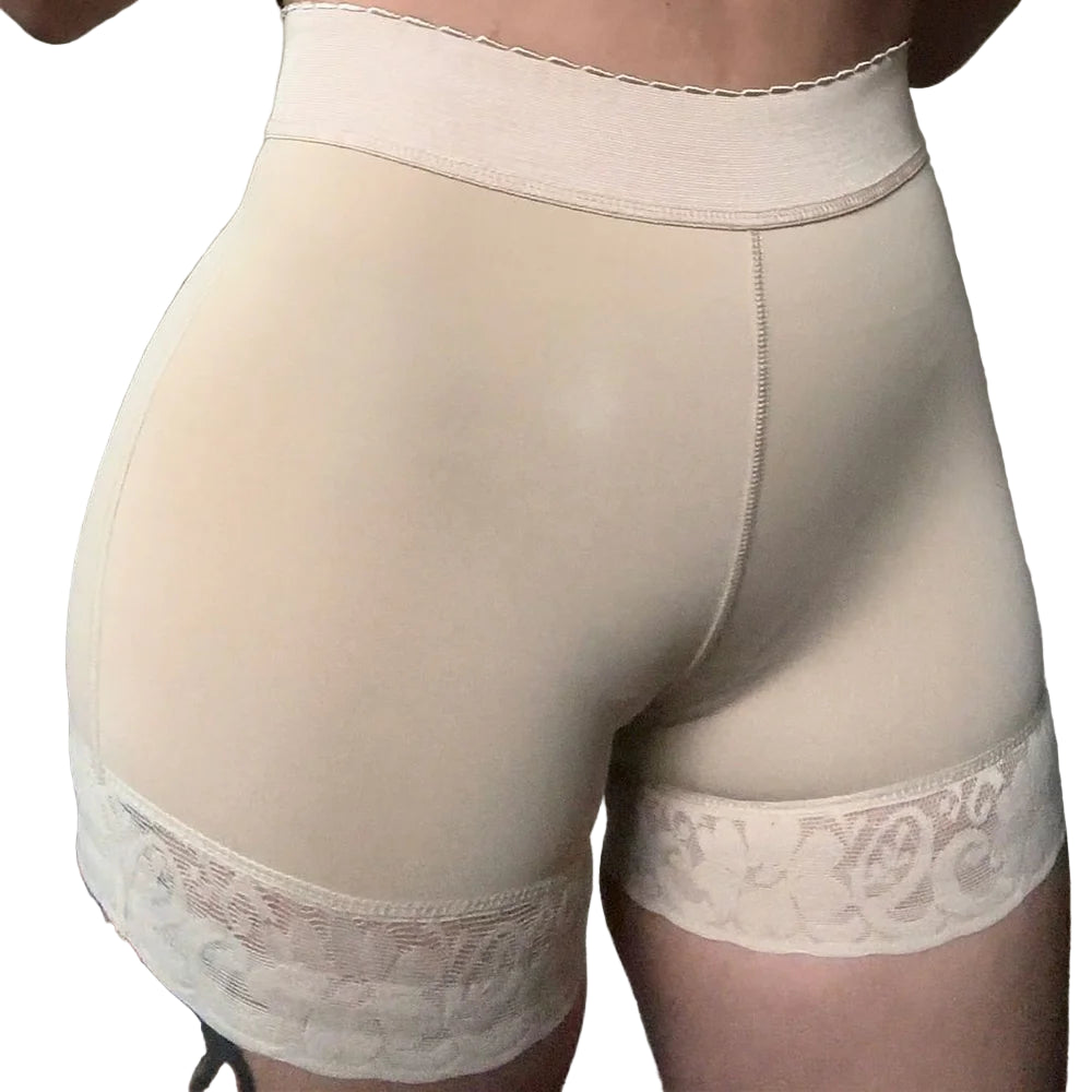 Beige shapewear with lace details on a plain background