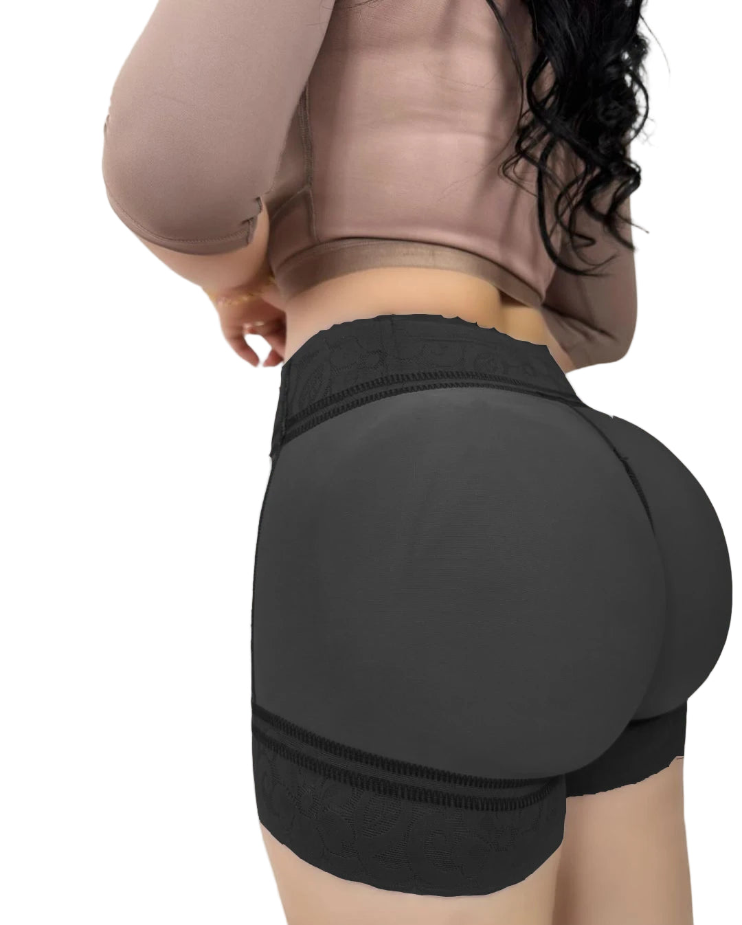 Person wearing black athletic shorts on a beige background