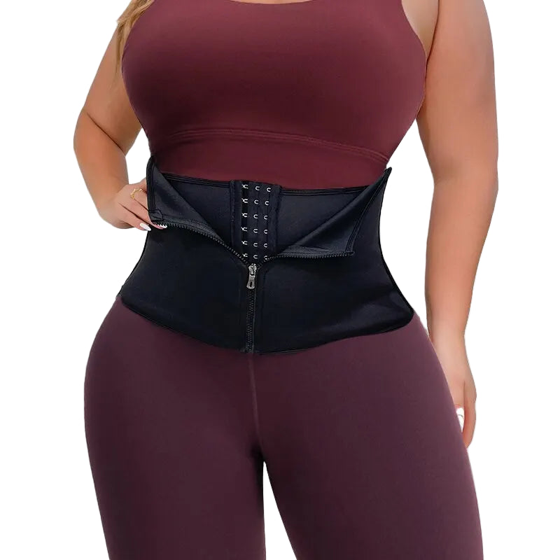 Person wearing a black waist trainer with burgundy top and leggings on a white background