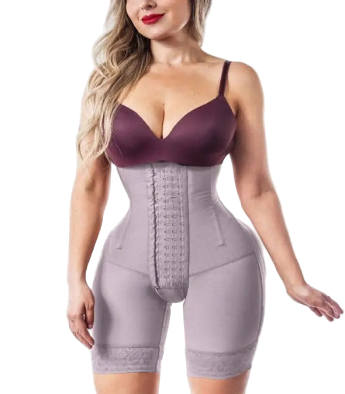 Woman wearing a purple bra and gray waist trainer on a white background