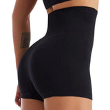 Black athletic shorts worn by a person on a white background