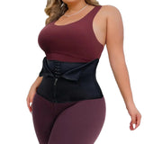 Woman wearing a black waist trainer with maroon top and pants on a white background