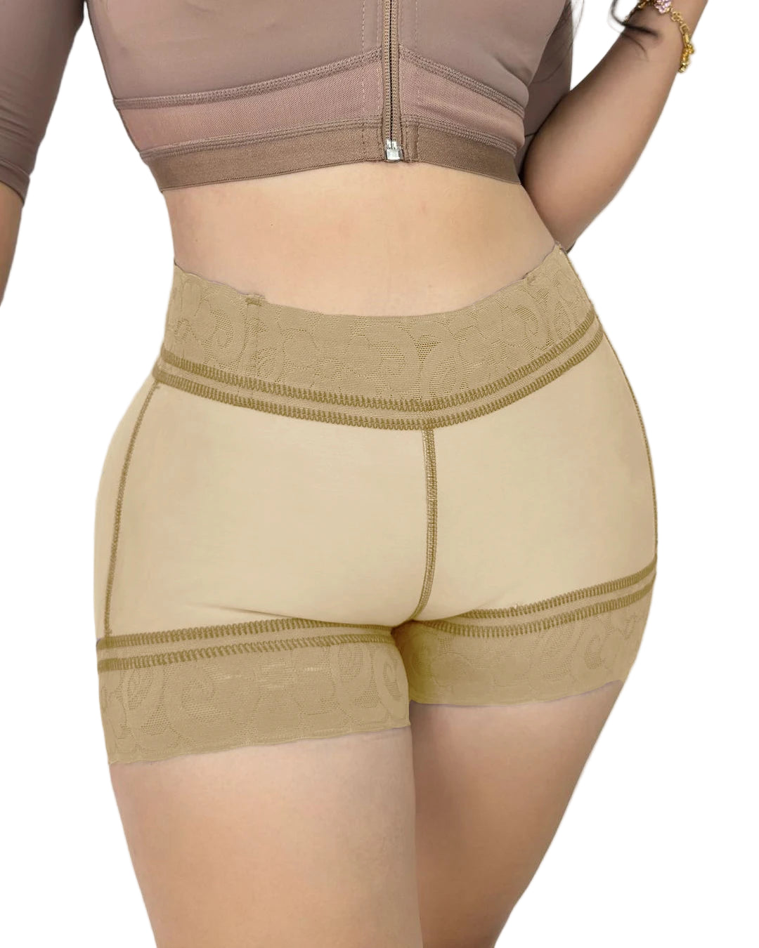 Beige shapewear shorts worn by a person on a white background