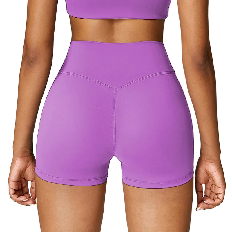 Purple athletic shorts worn by a person on a white background