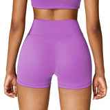 Purple athletic shorts worn by a person on a white background