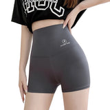 Person wearing gray high-waisted shorts with a brand logo on a light background