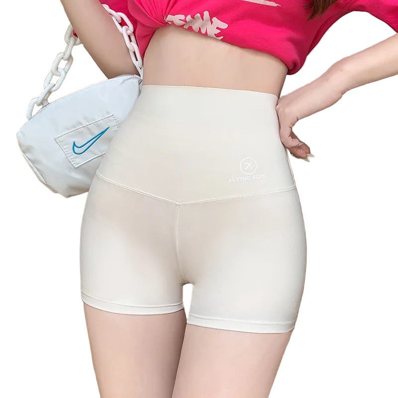 Person wearing white shorts with a pink top and white bag in the background