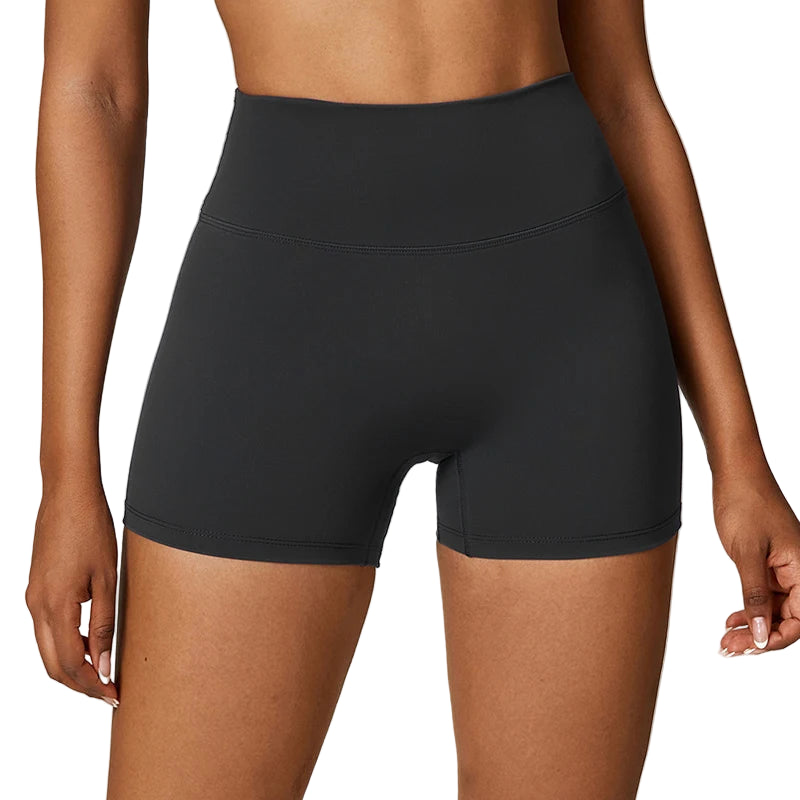 Black athletic shorts worn by a person on a white background