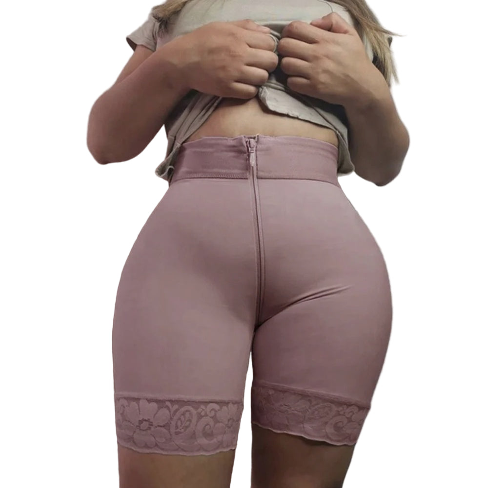 Person wearing pink high-waisted shorts with lace trim on a plain background