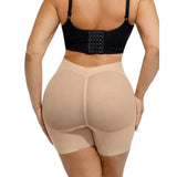 Beige shapewear shorts worn by a person on a white background