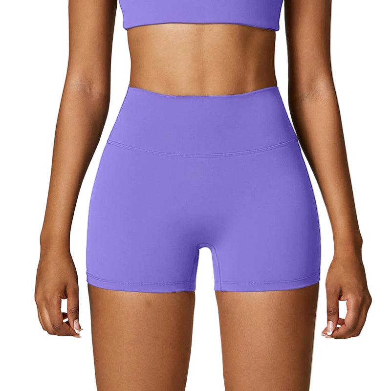 Purple athletic shorts worn by a person on a plain background