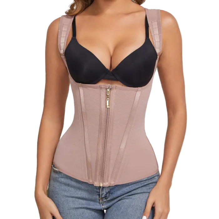 Woman wearing a beige waist trainer over a black bra and blue jeans.