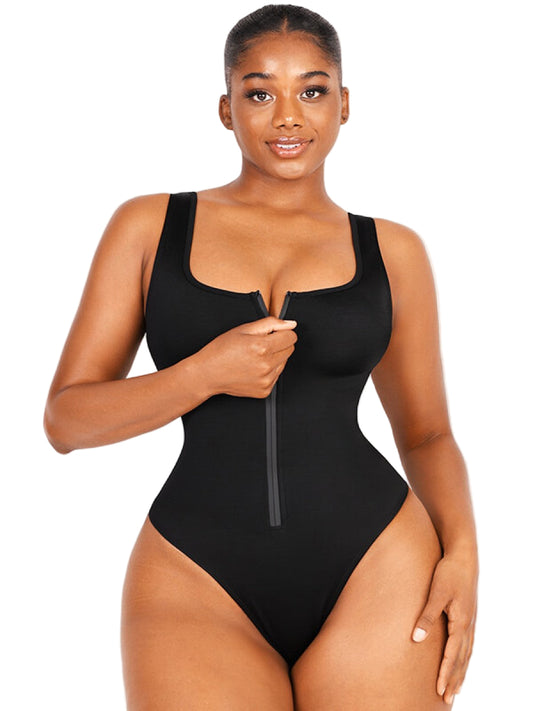 Woman wearing a black swimsuit with a zipper detail on a white background