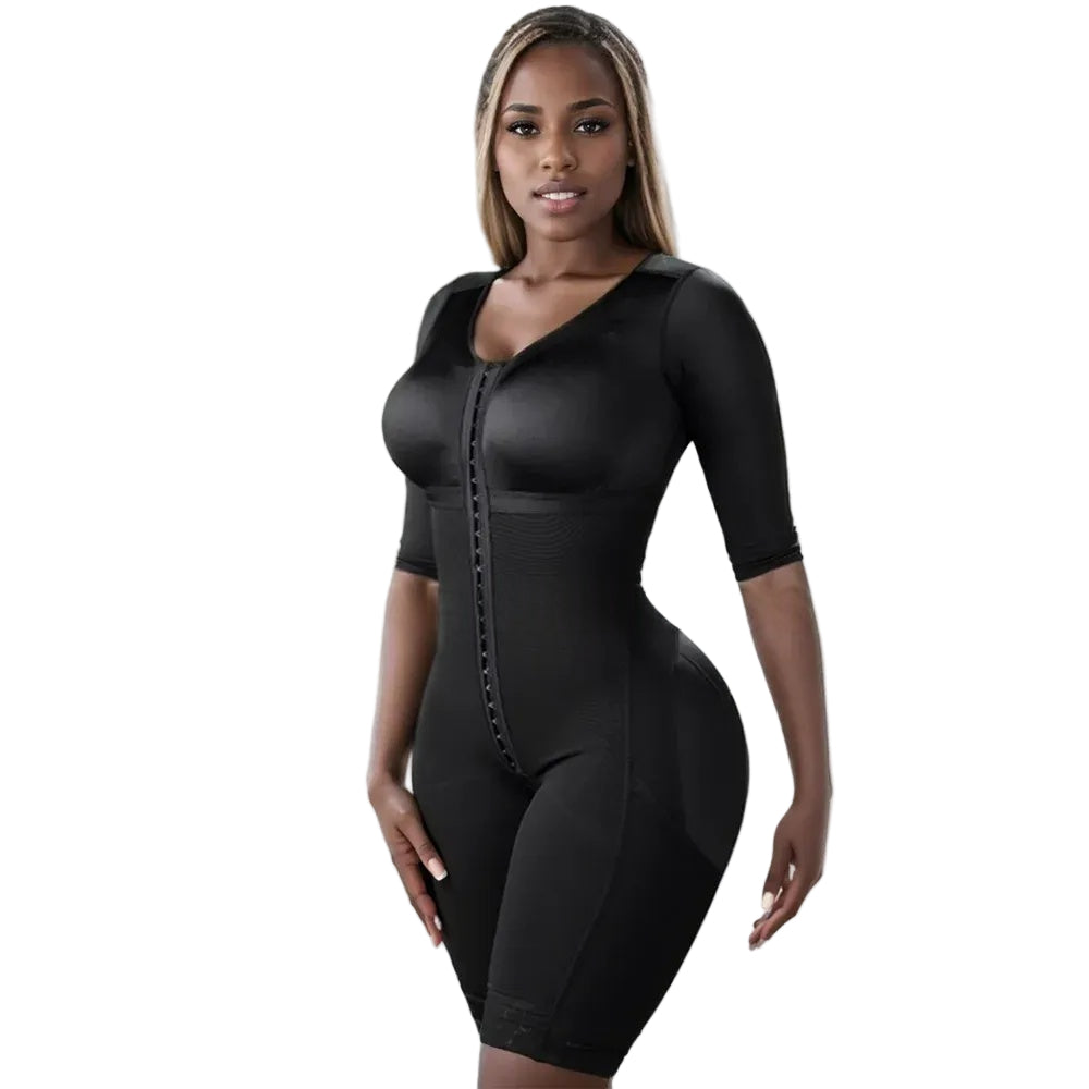 Woman wearing a black bodycon dress against a white curtain background