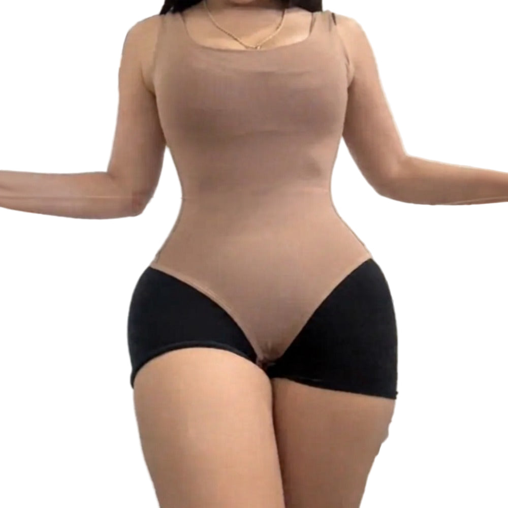 Person wearing a beige bodysuit with black underwear in an indoor setting