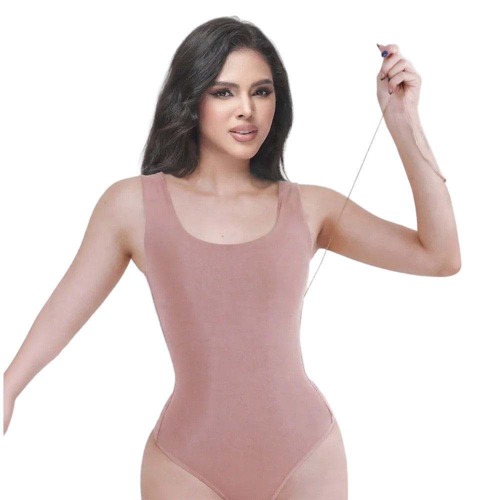 Woman wearing a pink bodysuit against a white background