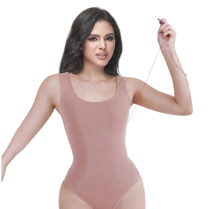 Woman wearing a pink bodysuit against a white background
