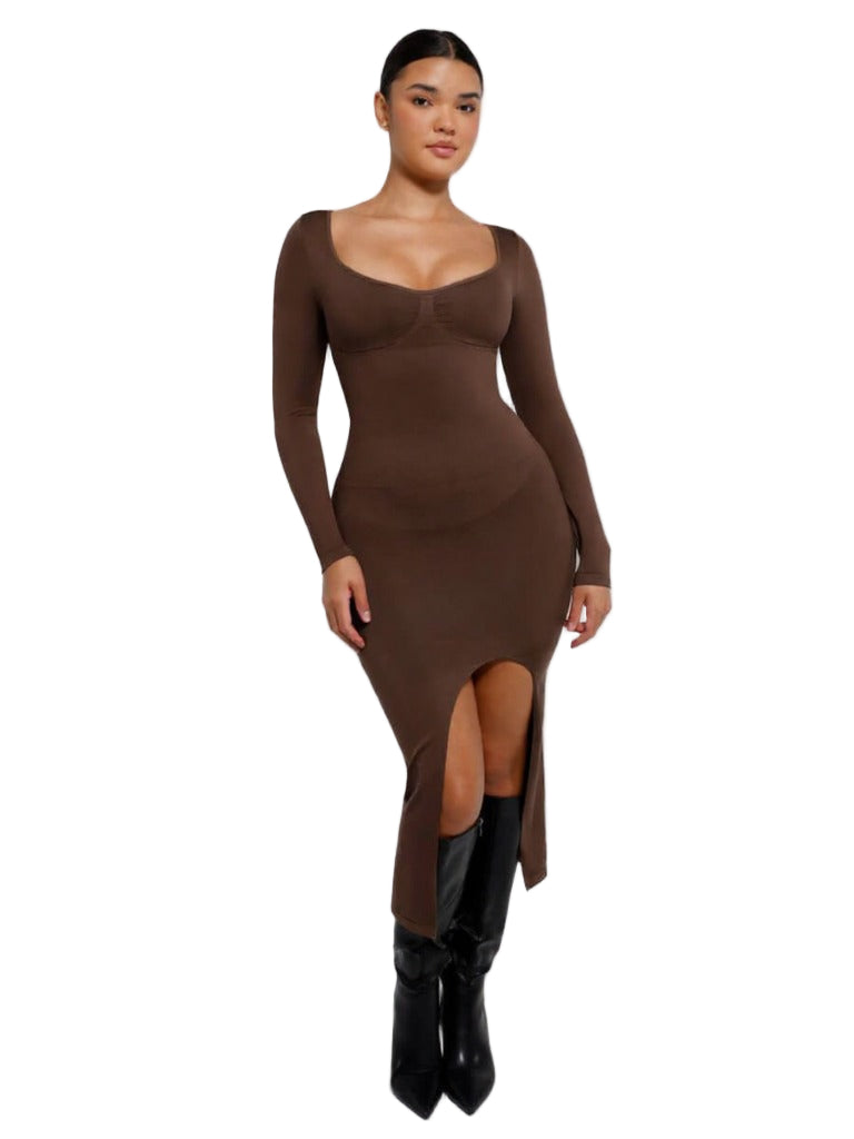 Woman wearing a brown long-sleeve dress with a slit on a white background