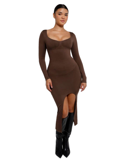 Woman wearing a brown long-sleeve dress with a slit on a white background