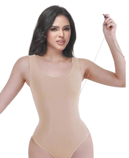 Woman wearing a beige bodysuit against a white background